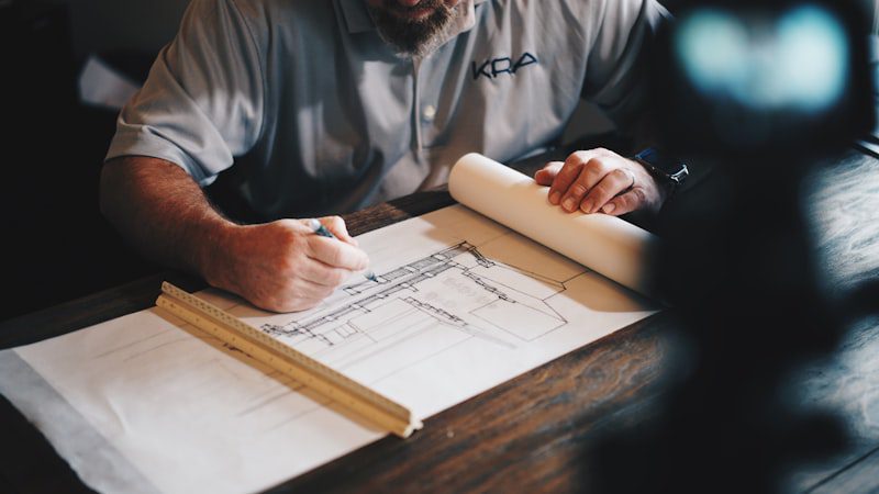 Architect reviewing blueprints in studio